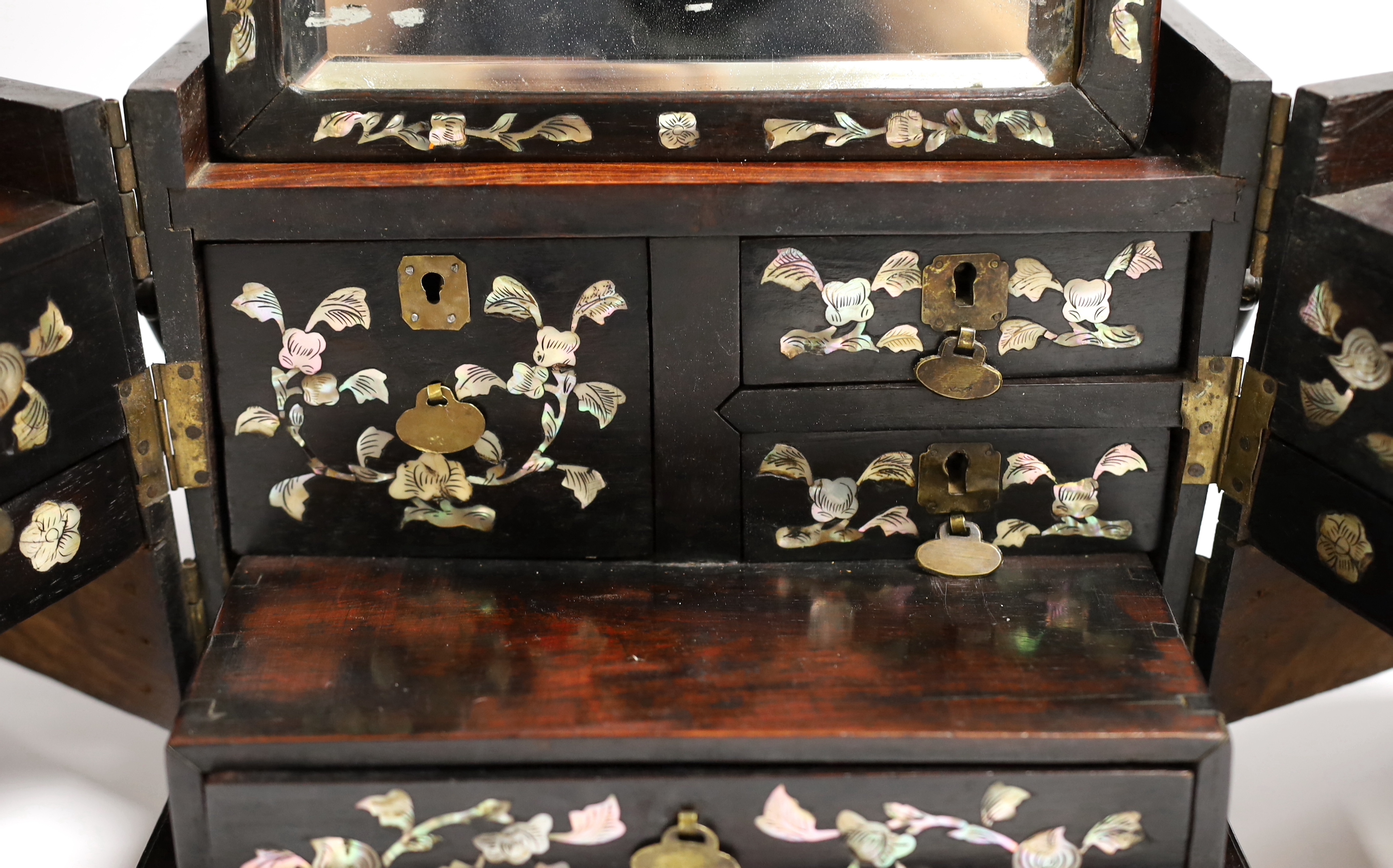 A Chinese mother-of- pearl inlaid hongmu vanity cabinet, late Qing dynasty, with fitted interior comprising a mirror, drawers, etc. 24cm x 31cm x 20cm